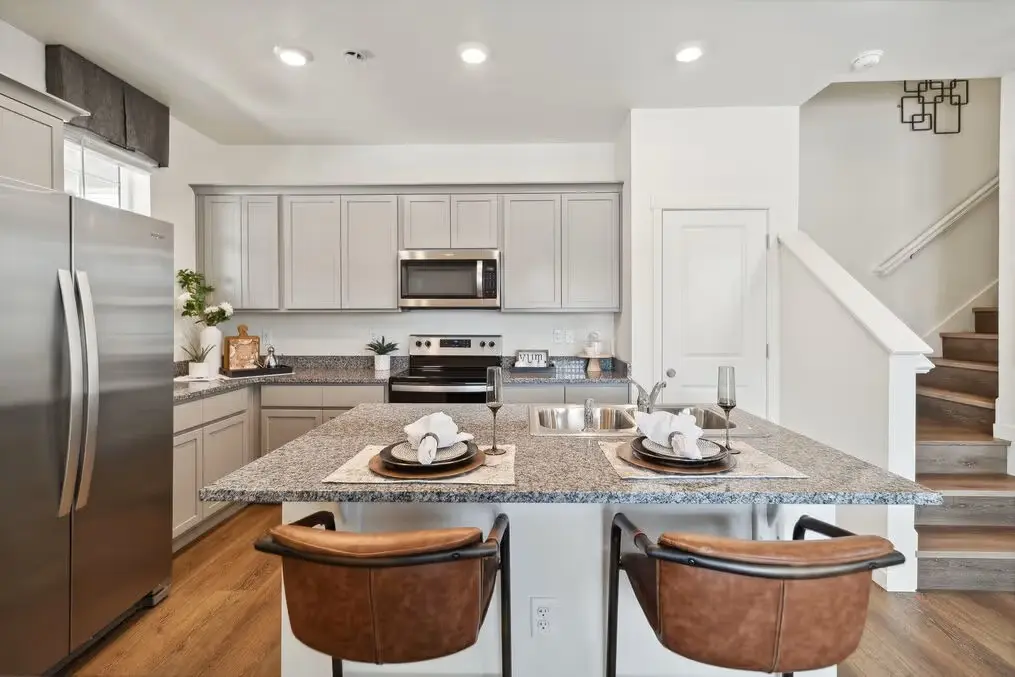 Fully equipped kitchen with granite island seating in a furnished Aurora, Colorado rental